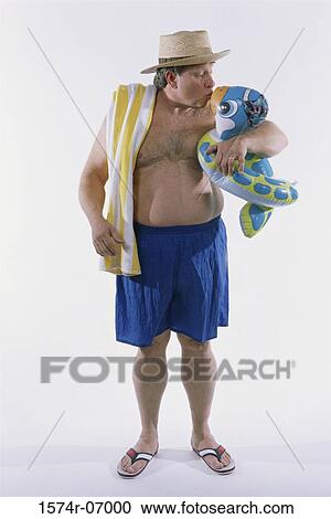 Mid adult man kissing an inflatable ring View Large Photo Image Stock Image - Mid adult man kissing an inflatable ring. Fotosearch
