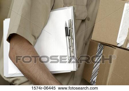 Mid section view of a man carrying a clipboard View Large Photo Image Stock Photography - Mid section view of a man carrying a clipboard. Fotosearch