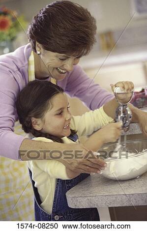 Mother and daughter baking a cake together View Large Photo Image Stock Image - Mother and daughter baking a cake together. Fotosearch