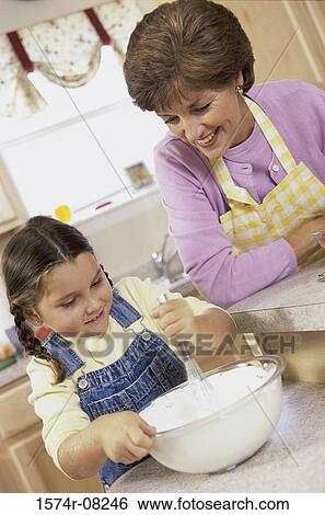 Mother and daughter baking a cake together View Large Photo Image Stock Photograph - Mother and daughter baking a cake together. Fotosearch