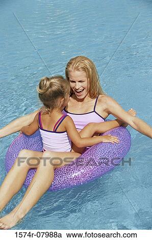 Mother and her daughter playing in a swimming pool View Large Photo Image Stock Image - Mother and her daughter playing in a swimming pool. Fotosearch