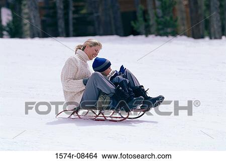 Picture - Mother and son together on a sled. Fotosearch
