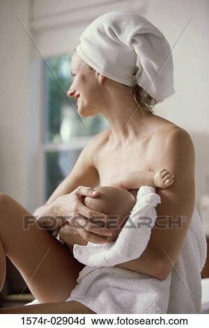 Stock Image - Mother breastfeeding her baby boy. Fotosearch
