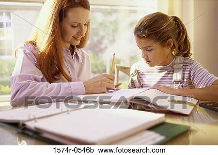 Mother helping her daughter with math homework View Large Photo Image Stock Image - Mother helping her daughter with math homework. Fotosearch
