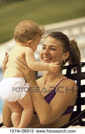 Stock Image - Mother holding her baby boy. Fotosearch