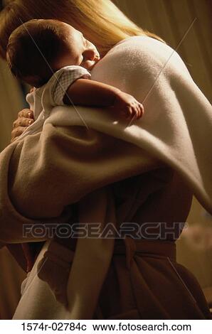 Mother holding her sleeping baby boy View Large Photo Image Stock Image - Mother holding her sleeping baby boy. Fotosearch