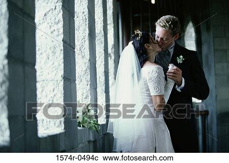 Stock Image - Newly married couple kissing. Fotosearch