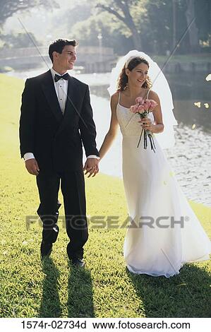 Newlywed couple holding h View Large Photo Image Stock Image - Newlywed couple holding h. Fotosearch