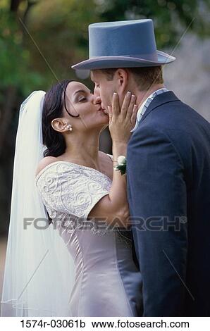 Newlywed couple kissing each other View Large Photo Image Stock Image - Newlywed couple kissing each other. Fotosearch