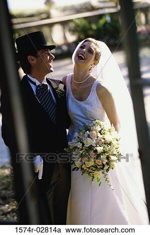 Newlywed couple laughing together View Large Photo Image Stock Image - Newlywed couple laughing together. Fotosearch