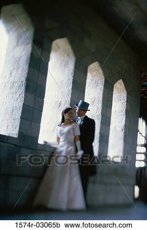 Newlywed couple standing in a castle View Large Photo Image Stock Image - Newlywed couple standing in a castle. Fotosearch