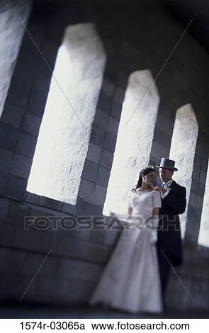 Stock Image - Newlywed couple standing side by side. Fotosearch