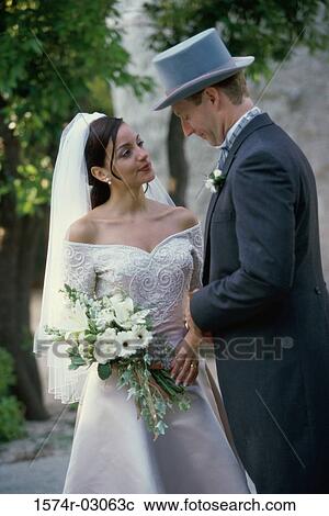 Stock Image - Newlywed couple standing together. Fotosearch