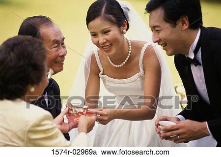 Stock Image - Newlywed couple with their parents. Fotosearch