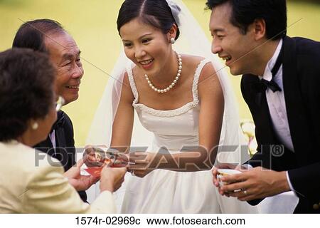 Stock Image - Newlywed couple with their parents. Fotosearch