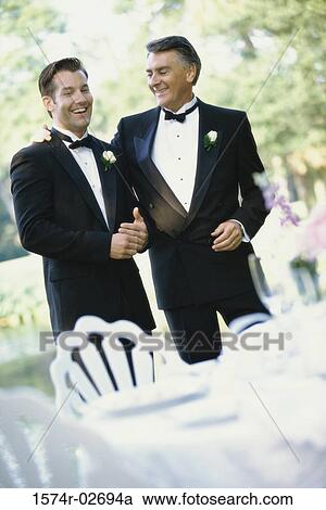 Stock Image - Newlywed young man talking with his father. Fotosearch