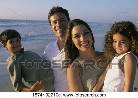 Parents holding their son and daughter on the beach View Large Photo Image Stock Image - Parents holding their son and daughter on the beach. Fotosearch