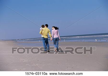 Parents playing with their daughter on the beach View Large Photo Image Stock Image - Parents playing with their daughter on the beach. Fotosearch