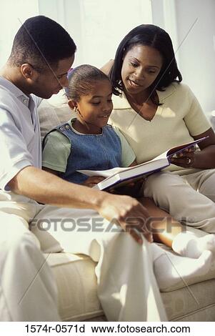 Parents reading a book with their daughter View Large Photo Image Stock Image - Parents reading a book with their daughter. Fotosearch