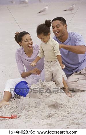 Parents with their daughter on the beach View Large Photo Image Stock Image - Parents with their daughter on the beach. Fotosearch