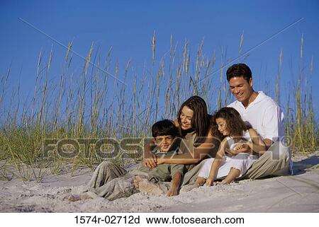 Parents with their son and daughter on the beach View Large Photo Image Stock Image - Parents with their son and daughter on the beach. Fotosearch