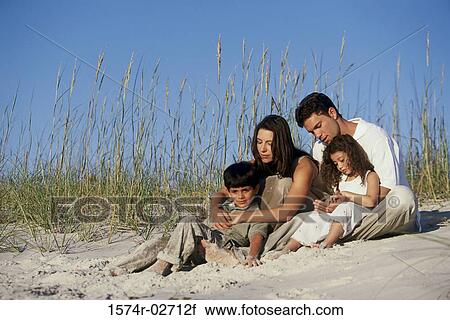 Parents with their son and daughter on the beach View Large Photo Image Stock Image - Parents with their son and daughter on the beach. Fotosearch