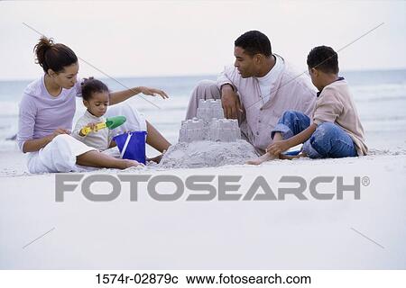 Parents with their son and daughter on the beach View Large Photo Image Stock Image - Parents with their son and daughter on the beach. Fotosearch