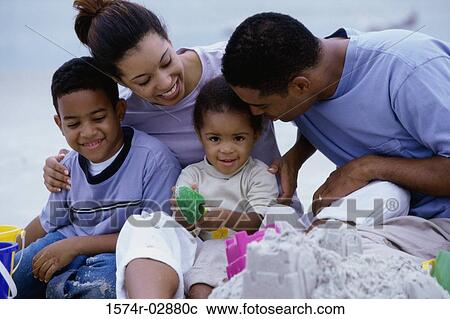 Parents with their son and daughter on the beach View Large Photo Image Stock Image - Parents with their son and daughter on the beach. Fotosearch