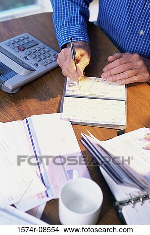 Person writing a check View Large Photo Image Picture - Person writing a check. Fotosearch