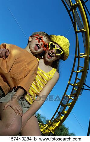 Portrait of a boy and a girl at an amusement park View Large Photo Image Stock Image - Portrait of a boy and a girl at an amusement park. Fotosearch