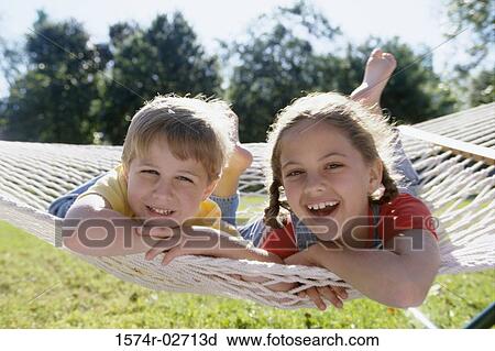 Portrait of a boy and a girl lying on a hammock View Large Photo Image Stock Image - Portrait of a boy and a girl lying on a hammock. Fotosearch