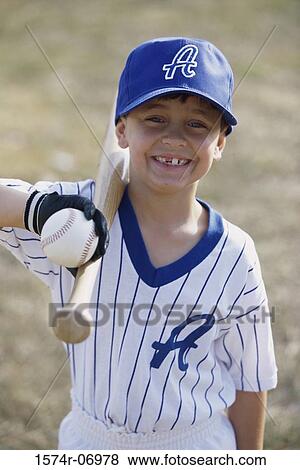 Stock Photo - Portrait of a boy holding a baseball bat. Fotosearch