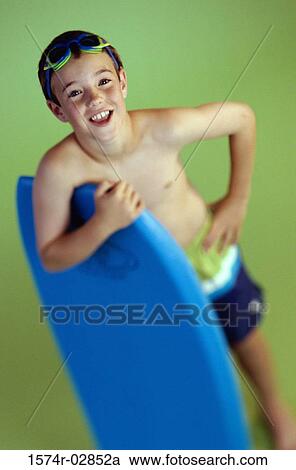 Portrait of a boy holding a boogie board View Large Photo Image Stock Image - Portrait of a boy holding a boogie board. Fotosearch