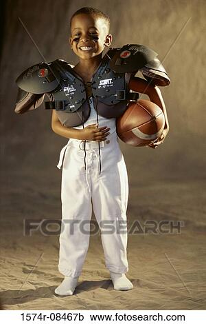 Portrait of a boy in a football uniform smiling View Large Photo Image Stock Image - Portrait of a boy in a football uniform smiling. Fotosearch