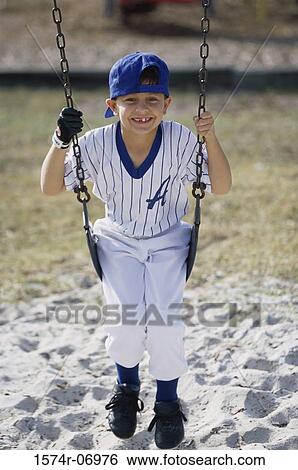 Portrait of a boy sitting on a swing View Large Photo Image Stock Photograph - Portrait of a boy sitting on a swing. Fotosearch