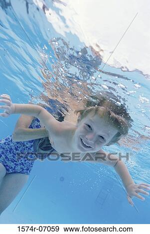 Portrait of a boy swimming underwater View Large Photo Image Stock Photo - Portrait of a boy swimming underwater. Fotosearch