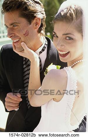 Portrait of a bride holding her groom's face View Large Photo Image Stock Image - Portrait of a bride holding her groom's face. Fotosearch