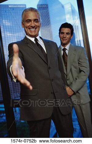 Portrait of a business executive extending his arm to shake hands View Large Photo Image Stock Image - Portrait of a business executive extending his arm to shake hands. Fotosearch