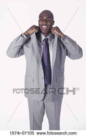 Portrait of a businessman adjusting his collar View Large Photo Image Stock Photography - Portrait of a businessman adjusting his collar. Fotosearch