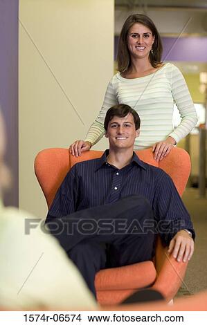 Portrait of a businessman and a businesswoman smiling in an office View Large Photo Image Picture - Portrait of a businessman and a businesswoman smiling in an office. Fotosearch