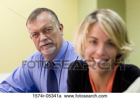 Portrait of a businessman and a businesswoman in an office View Large Photo Image Stock Image - Portrait of a businessman and a businesswoman in an office. Fotosearch