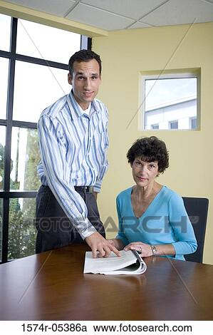 Portrait of a businessman and a businesswoman in an office View Large Photo Image Stock Image - Portrait of a businessman and a businesswoman in an office. Fotosearch