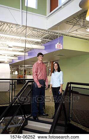 Portrait of a businessman and a businesswoman standing on stairs View Large Photo Image Stock Image - Portrait of a businessman and a businesswoman standing on stairs. Fotosearch