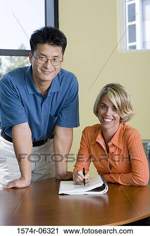 Portrait of a businessman and a businesswoman in an office View Large Photo Image Stock Image - Portrait of a businessman and a businesswoman in an office. Fotosearch