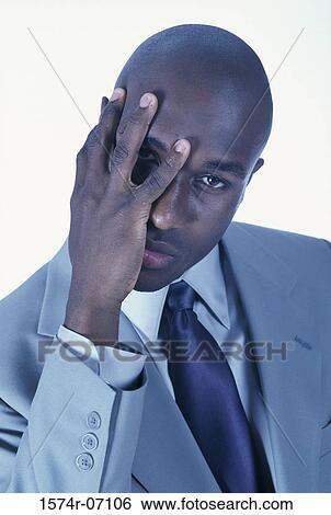 Portrait of a businessman covering his face with his hand View Large Photo Image Stock Photograph - Portrait of a businessman covering his face with his hand. Fotosearch