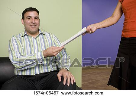 Portrait of a businessman giving a document to a businesswoman View Large Photo Image Stock Photo - Portrait of a businessman giving a document to a businesswoman. Fotosearch