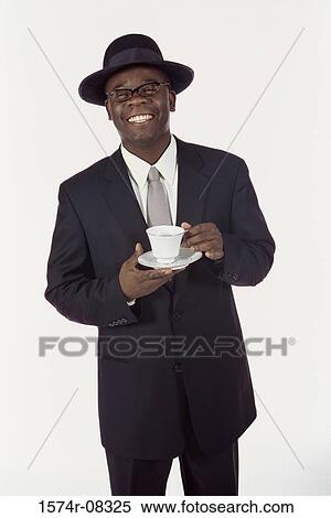 Portrait of a businessman holding a cup of coffee View Large Photo Image Stock Photography - Portrait of a businessman holding a cup of coffee. Fotosearch