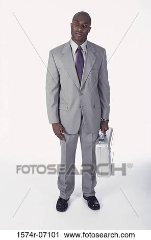 Portrait of a businessman holding a briefcase View Large Photo Image Stock Image - Portrait of a businessman holding a briefcase. Fotosearch