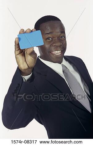 Portrait of a businessman holding a blank card View Large Photo Image Stock Photo - Portrait of a businessman holding a blank card. Fotosearch