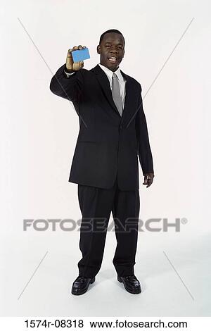 Stock Photo - Portrait of a businessman holding a blank card. Fotosearch